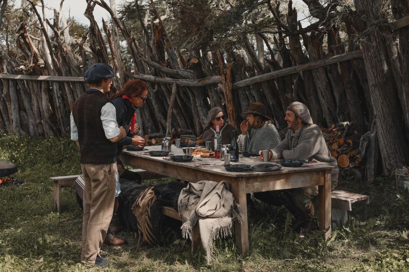 Group of friends eating a traditional meal in Tierra del Fuego, Patagonia